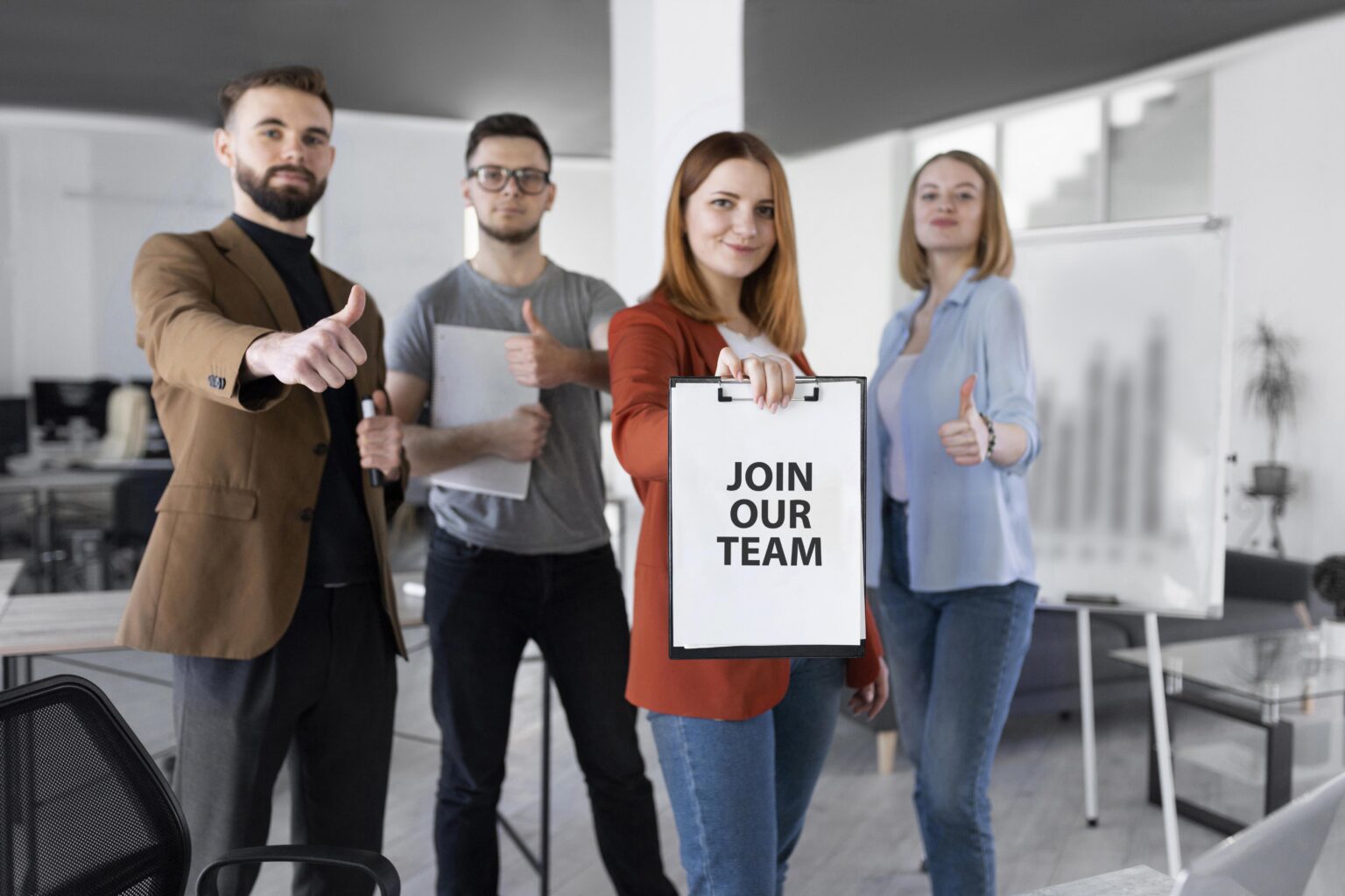 woman-holding-clipboard-with-join-our-team-message-1536x1024